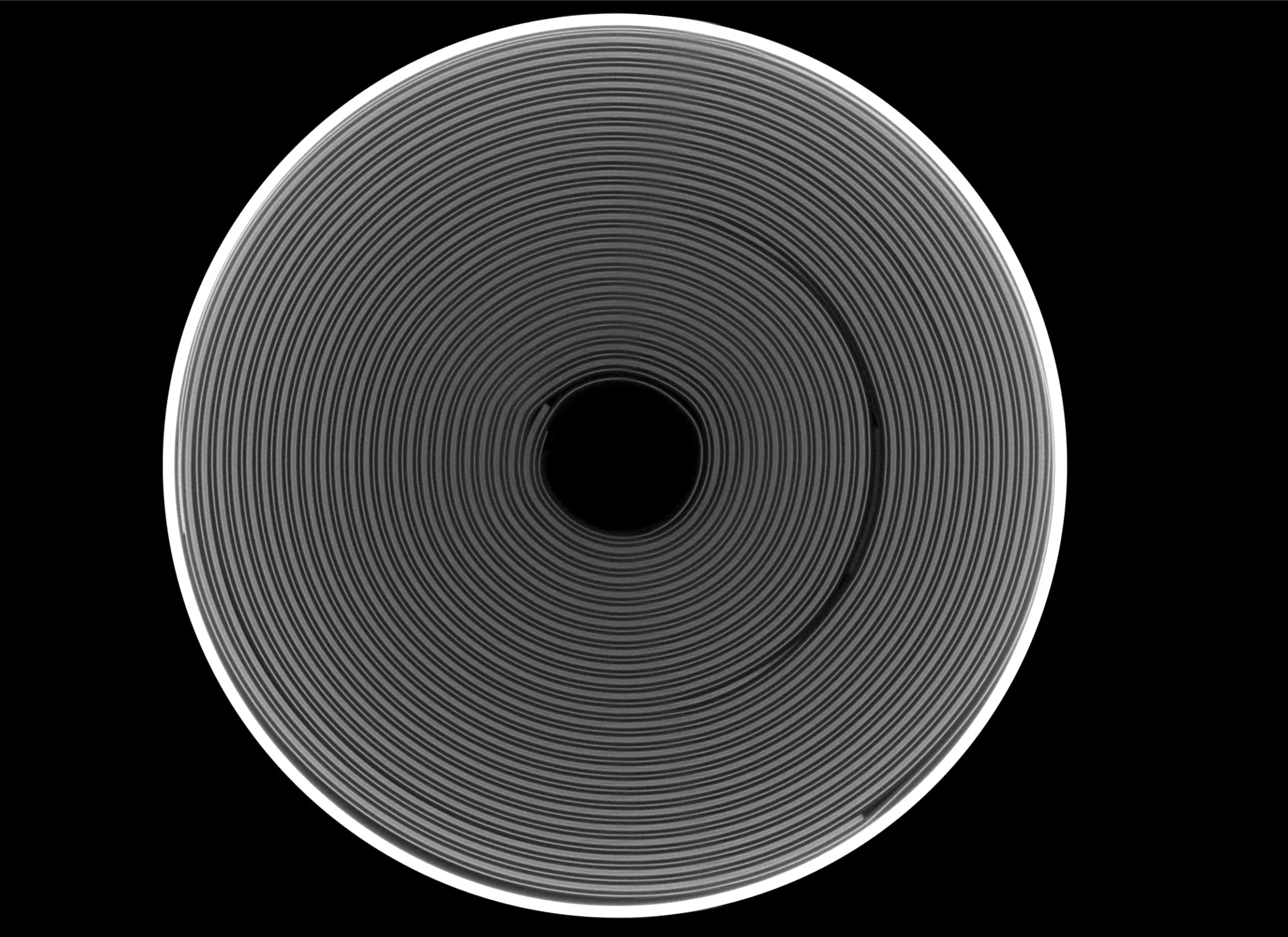 Top-view X-ray image of a cylindrical battery cell showing the wound electrode layers