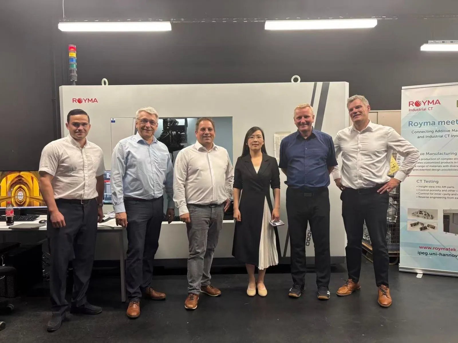 The Royma and iWP teams in front of a Royma CT system