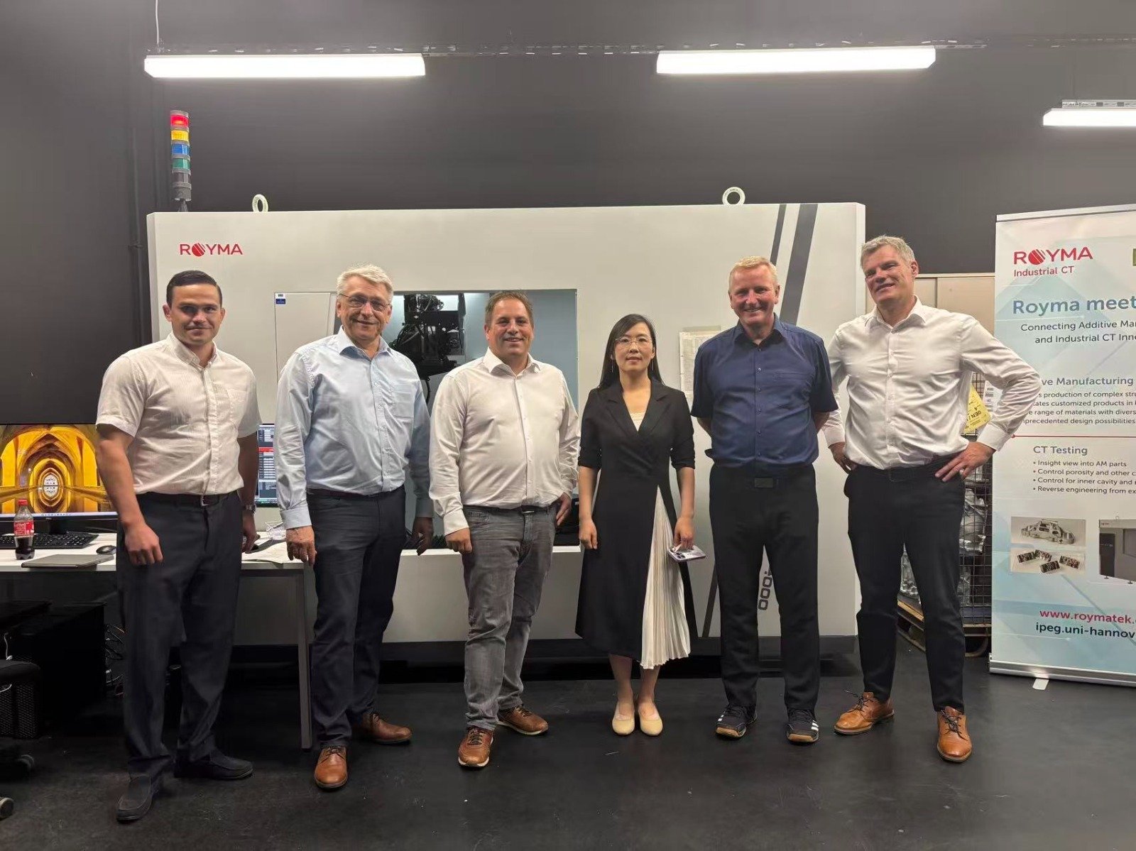The Royma and iWP teams in front of a Royma CT system